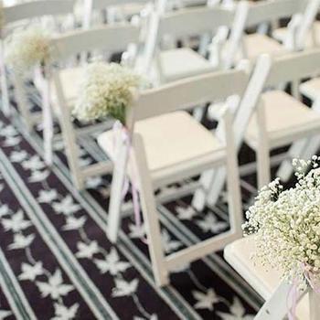 Rows of chairs at wedding venue .