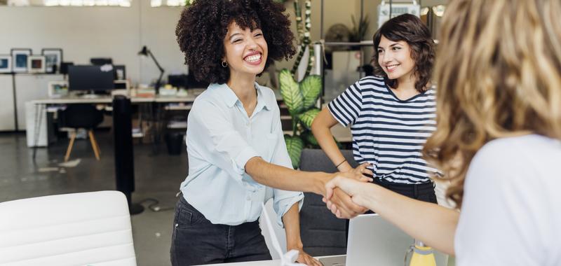 three women meeting and shaking hands
