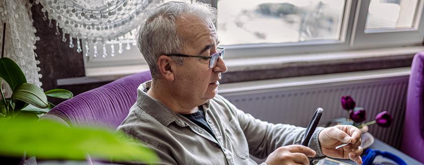 Senior Man collecting stamps from around the world