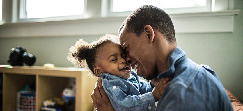 Father laughing with toddler daughter