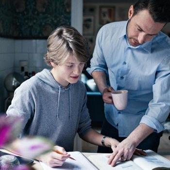 father helping son with homework
