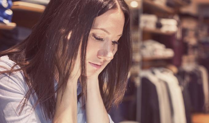 Serious woman looking down.
