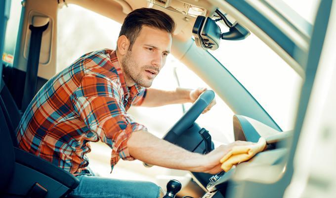 Man cleaning the interior of his car.