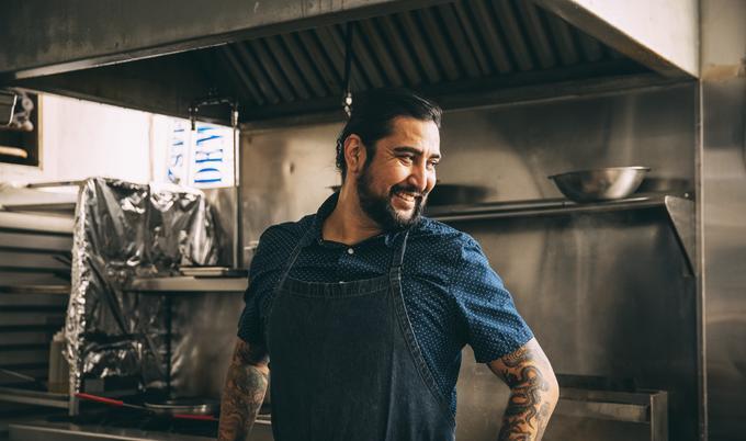Man standing in restaurant kitchen
