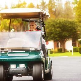 man driving golf cart