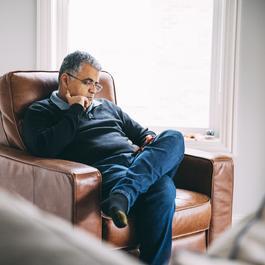 Man sitting in chair looking at phone