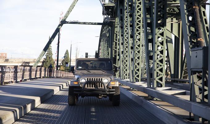 jeep driving on a bridge