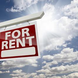 For Rent Sign with a view of the sky full of clouds.