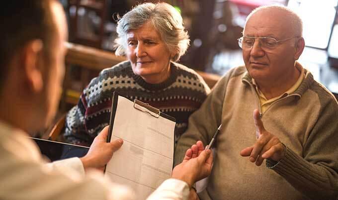 Older couple negotiating contract
