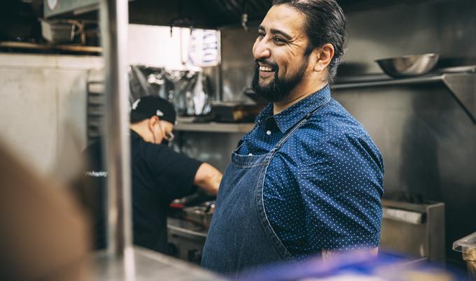 Man standing in restaurant kitchen