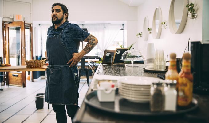 Man putting on apron