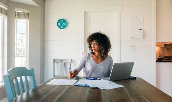 Woman doing finances at home.