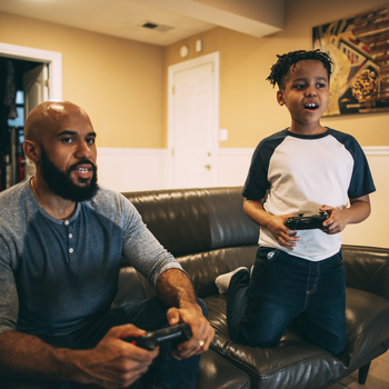 Father and son playing video games.