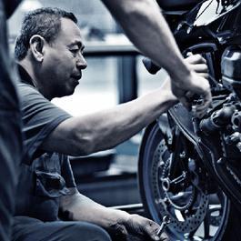 Mechanic working on a motorcycle.