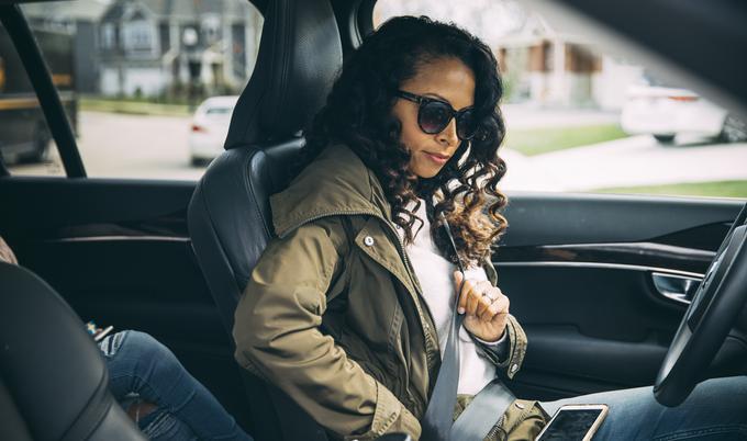 Woman buckling seat belt