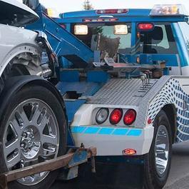 tow truck towing damaged vehicle