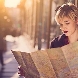 woman reading map on walkway