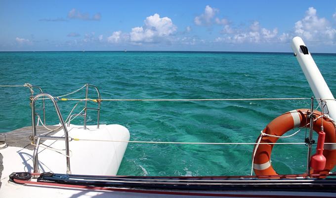 View of water and sky from boat deck.