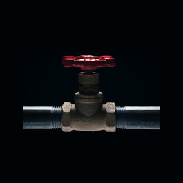 Red stop valve connecting two straight pipes.