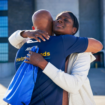 A man giving a woman a caring hug.