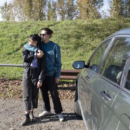 couple embracing near parked car
