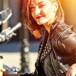 woman drinking coffee on motorcycle