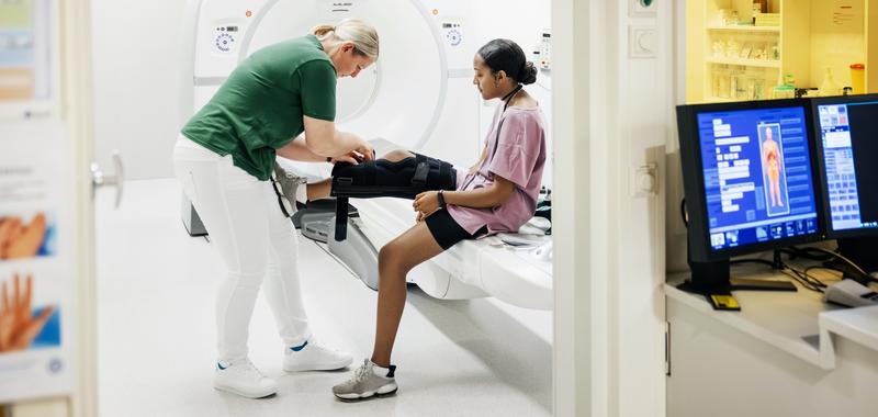 young girl with an injured leg being checked out at the doctor 