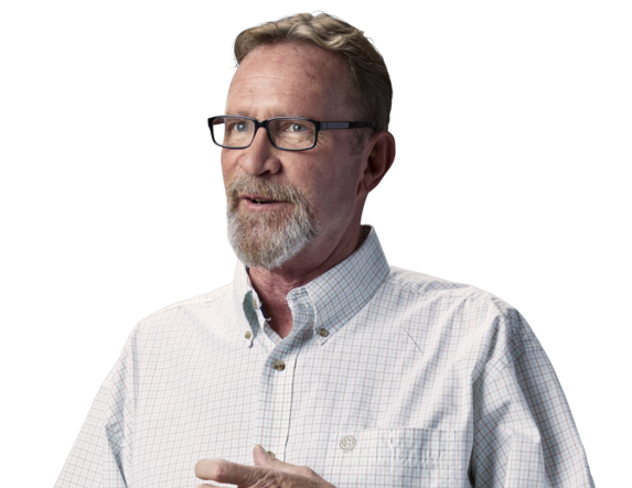 Older male standing with glasses and button up shirt scratching his hand portrait.