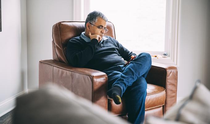 Man sitting in chair looking at phone