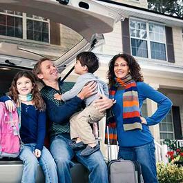 family at back of vehicle at home