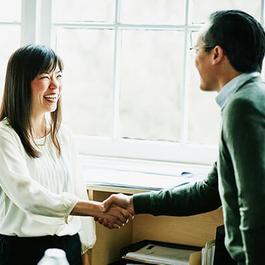 woman shaking man's hand
