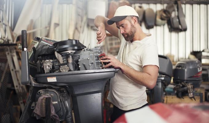Man fixing his boat motor
