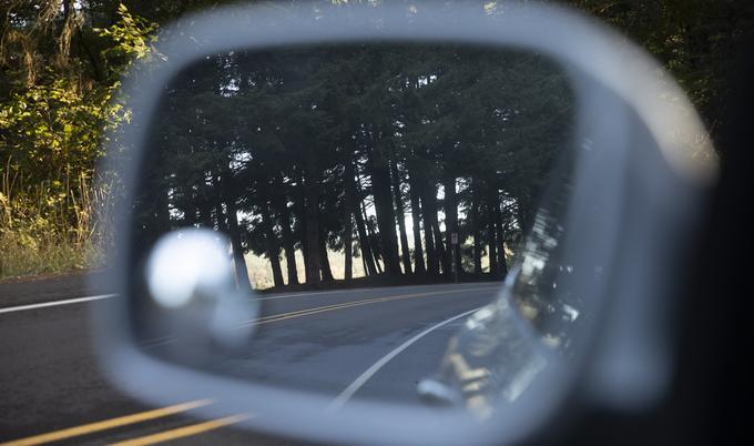 reflection of roadway in side mirror