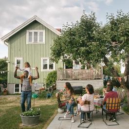 Family is relaxing and playing in backyard.