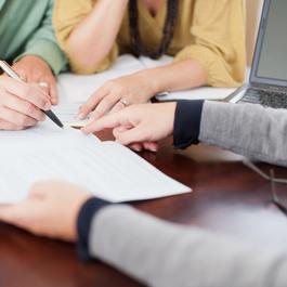 Signing a document on a table.