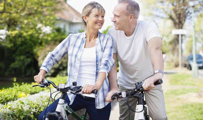 Man and woman sitting on bikes.