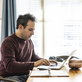 Man working from home at dining room table