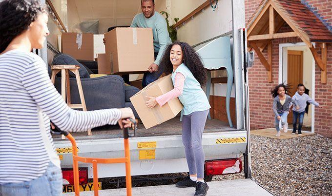 Family unloading moving truck