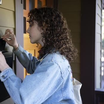 brunette woman checking mail