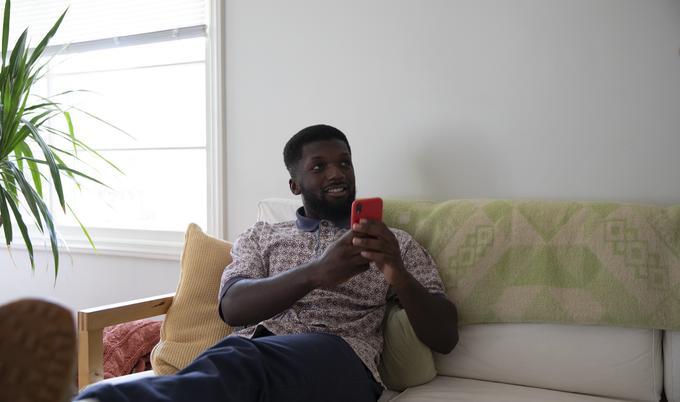 man looking up from phone