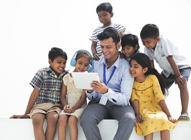 A business man showing a group of children his tablet