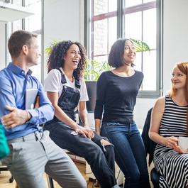 Co-workers in a conference room collaborating and enjoying their time together.