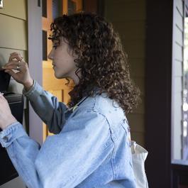  brunette woman checking mail