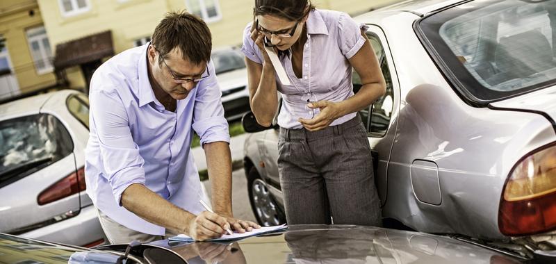 man and woman exchanging informaiton after a car accident 