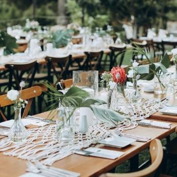 Wedding table setting with flowers and dinnerware.