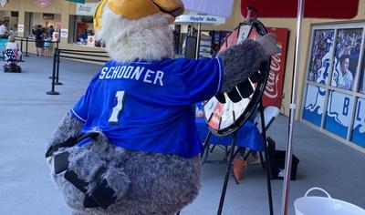 Shuckers mascot  Schooner spinning the Direct Auto prize wheel 