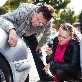 man-and-woman-examining-car-bumper-gettyimages.jpg