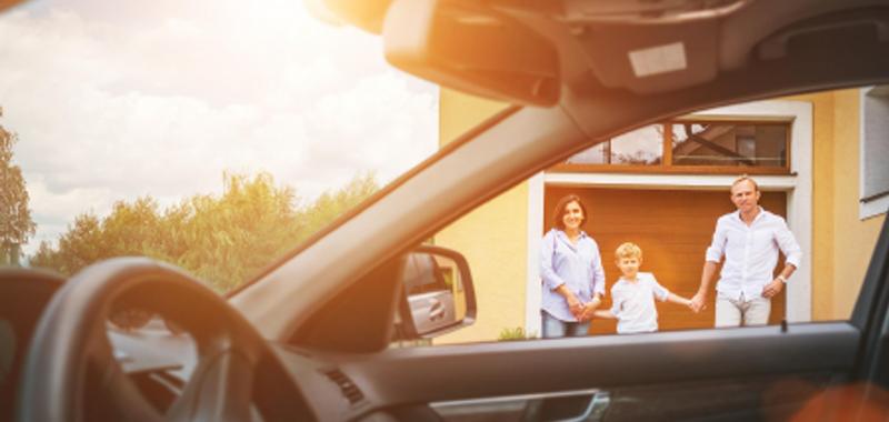 family outside of home looking into vehicle 