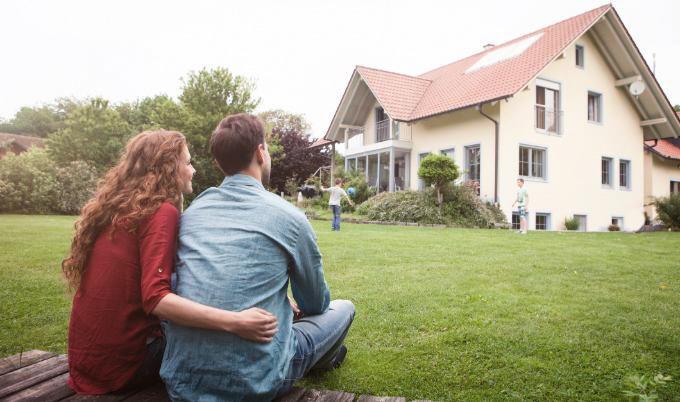parents watching sons play in yard