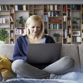 woman with laptop on couch